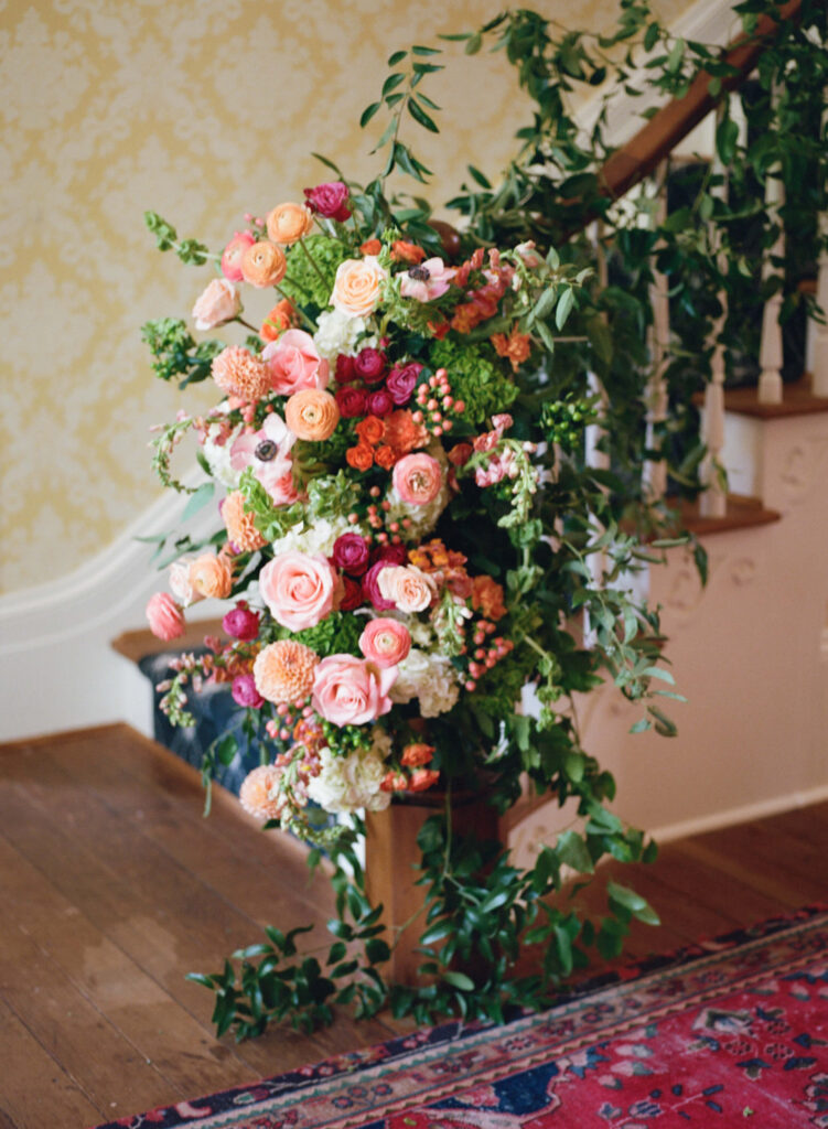 Staircase floral arrangement at a wedding at The Colonnade House in Columbus, MS