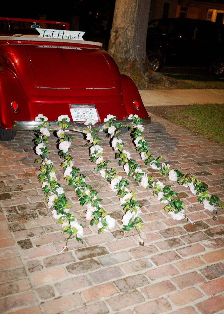 Classic red getaway car at a wedding at The Colonnade House in Columbus, MS
